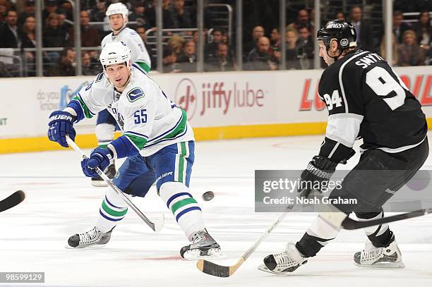 Shane O'Brien of the Vancouver Canucks skates with the puck against Ryan Smyth of the Los Angeles Kings in Game Four of the Western Conference...