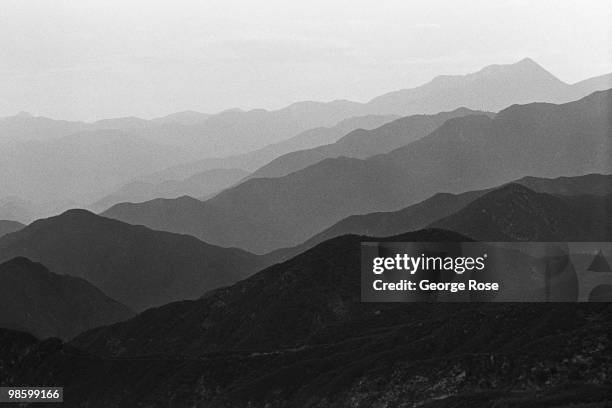 Smog and smoke choke the San Gabriel Mountains above this city creating unique patterns along the ridges in this 1975 Claremont, California, photo.