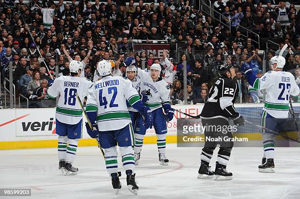 Steve Bernier, Kyle Wellwood and Alexander Edler of the Vancouver Canucks celebrate with teammates after a goal against the Los Angeles Kings in Game...