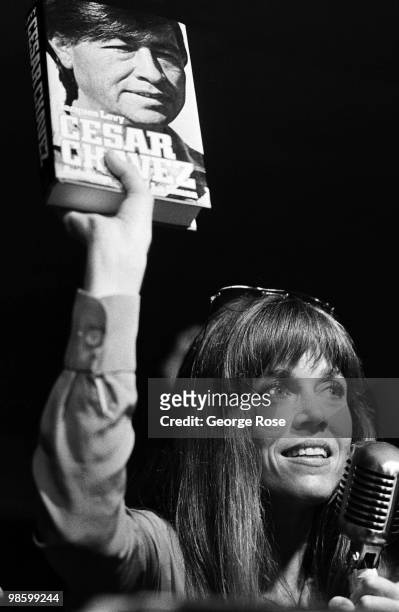 Political activist and Academy Award-winning actress, Jane Fonda, holds up a book on Cesar Chavez during the 1976 New York, New York, Democratic...