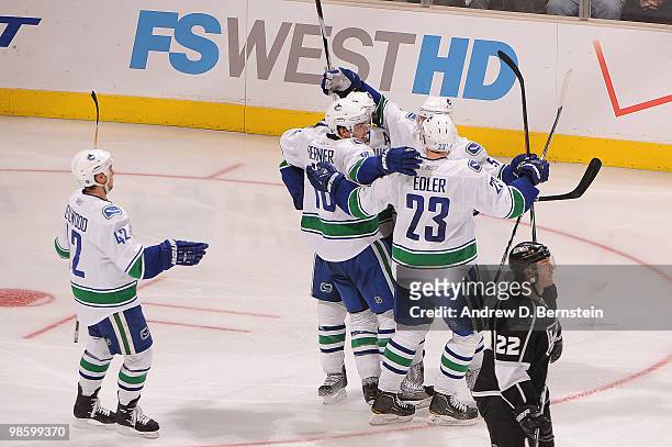 Steve Bernier, Kyle Wellwood and Alexander Edler of the Vancouver Canucks celebrate with teammates after a goal against the Los Angeles Kings in Game...