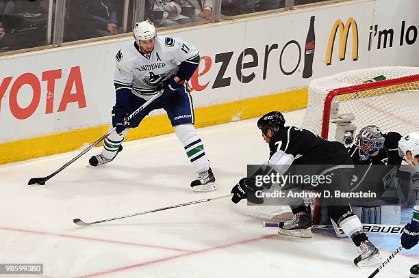 Ryan Kesler of the Vancouver Canucks skates with the puck against Rob Scuderi of the Los Angeles Kings in Game Four of the Western Conference...