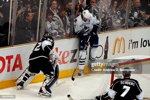 Jonathan Quick of the Los Angeles Kings tries to clear the puck against Ryan Kesler of the Vancouver Canucks in Game Four of the Western Conference...