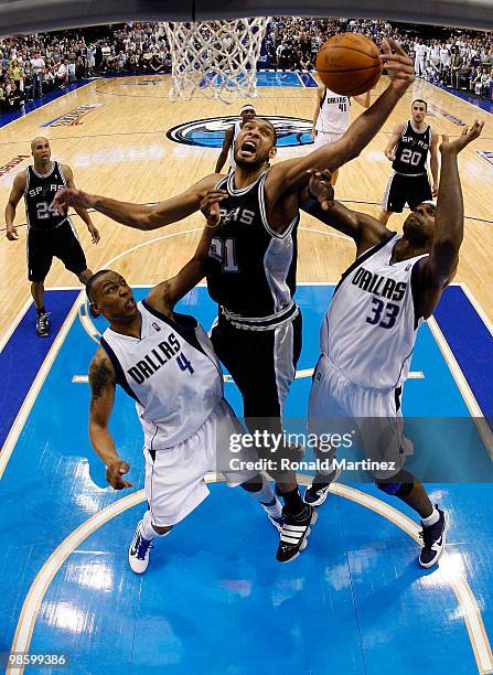 Forward Tim Duncan of the San Antonio Spurs grabs a rebound against Caron Butler and Brendan Haywood of the Dallas Mavericks in Game Two of the...