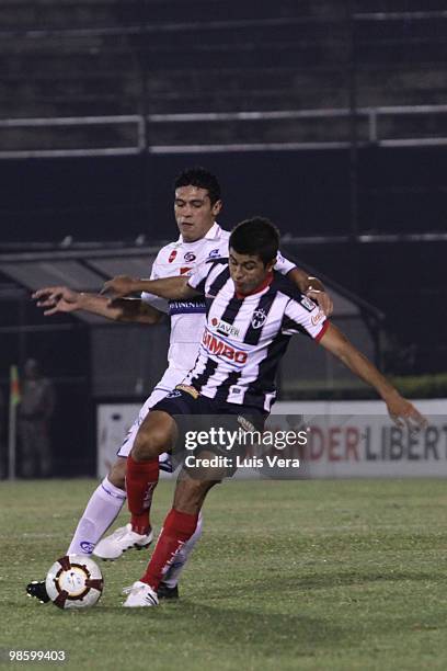 Victor Aquino of Paraguayan Nacional fights for the ball with Eduardo Guevara of Mexican Monterrey during their Copa Santander Libertadores de...