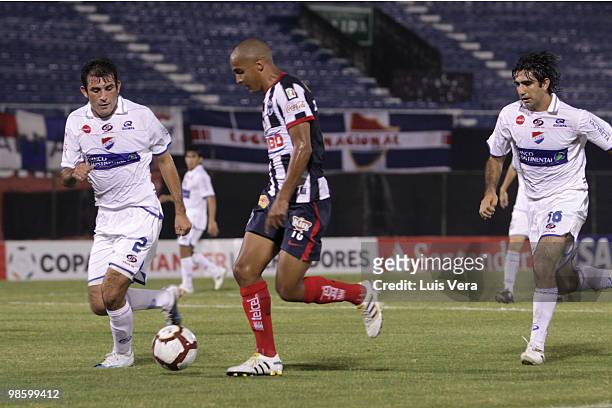 Alfredo Rojas and Ariel Bogado of Paraguayan Nacional fight for the ball with Abraham Carreno of Mexican Monterrey during their Copa Santander...