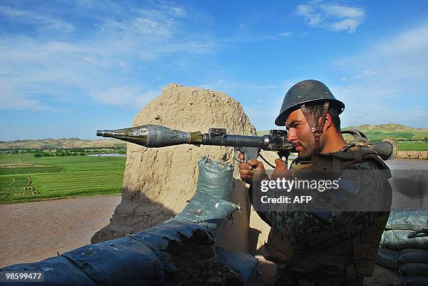 This photo taken on April 21, 2010 shows an Afghan National Army soldier handles a rocket-propelled grenade launcher as he keeps watch during a...