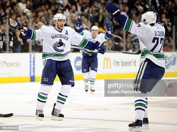 Ryan Kesler celebrates his empty net goal with Daniel Sedin of the Vancouver Canucks leading to a 6-4 victory over the Los Angeles Kings during the...