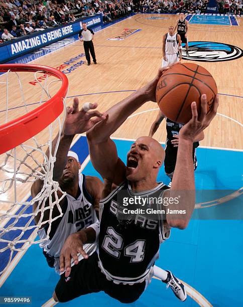 Richard Jefferson of the San Antonio Spurs goes in for the hard layup against Erick Dampier of the Dallas Mavericks in Game Two of the Western...