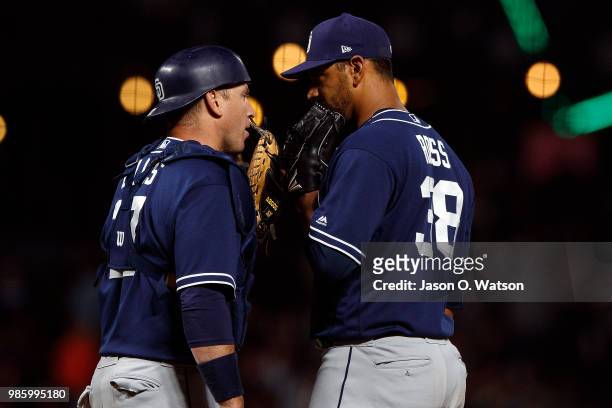 Ellis of the San Diego Padres talks to Tyson Ross during a mound visit against the San Francisco Giants during the seventh inning at AT&T Park on...
