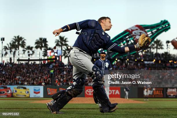 Ellis of the San Diego Padres catches a foul ball hit off the bat of Alen Hanson of the San Francisco Giants during the fifth inning at AT&T Park on...