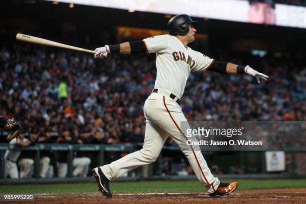 Joe Panik of the San Francisco Giants hits a double against the San Diego Padres during the fifth inning at AT&T Park on June 21, 2018 in San...