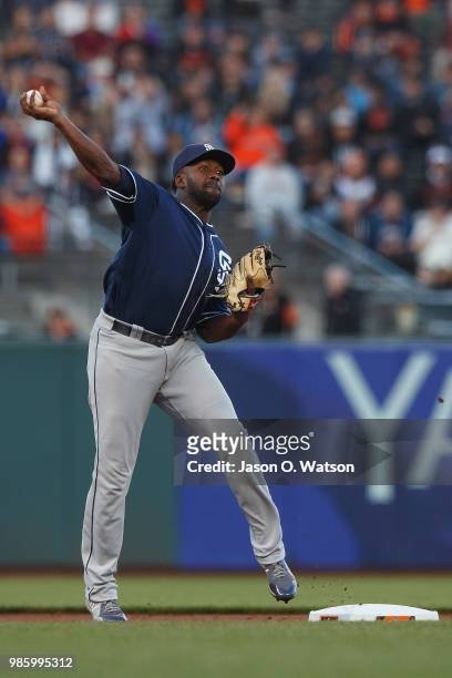 Jose Pirela of the San Diego Padres throws to first base to complete a double play against the San Francisco Giants during the first inning at AT&T...