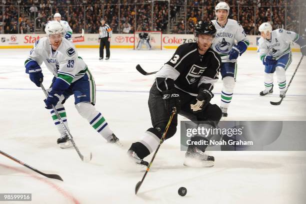 Fredrik Modin of the Los Angeles Kings reaches for the puck against Henrik Sedin of the Vancouver Canucks in Game Four of the Western Conference...