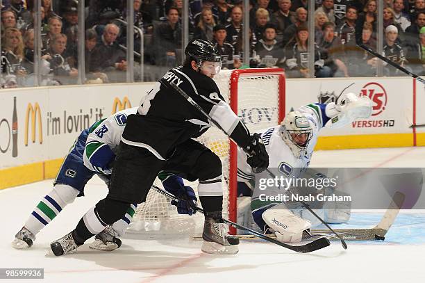 Drew Doughty of the Los Angeles Kings reaches for the puck against Roberto Luongo of the Vancouver Canucks in Game Four of the Western Conference...