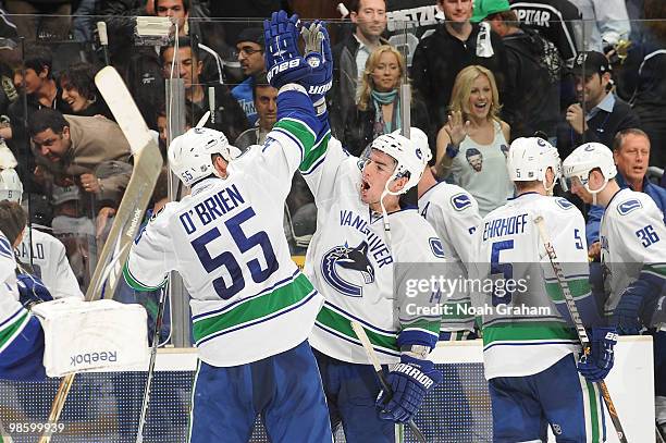 Shane O'Brien and Alexandre Burrows of the Vancouver Canucks celebrate after defeating the Los Angeles Kings in Game Four of the Western Conference...