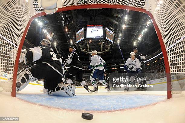 Henrik Sedin and Christian Ehrhoff of the Vancouver Canucks celebrate after a goal against Jonathan Quick, Rob Scuderi and Drew Doughty of the Los...
