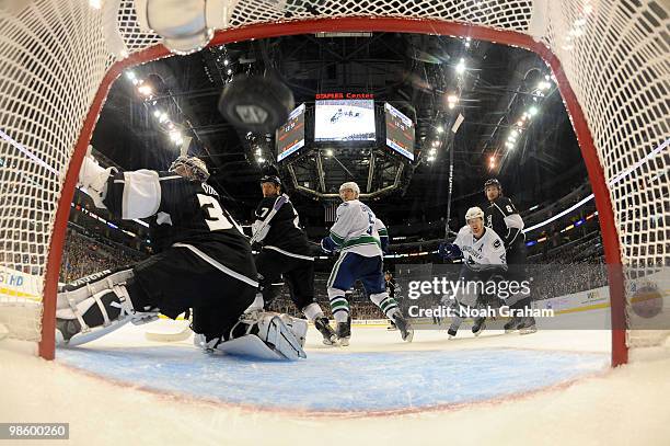 Henrik Sedin and Christian Ehrhoff of the Vancouver Canucks celebrate after a goal against Jonathan Quick, Rob Scuderi and Drew Doughty of the Los...