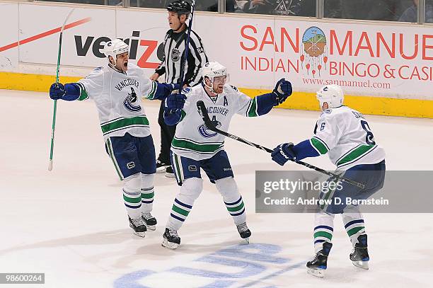 Henrik Sedin and Sami Salo of the Vancouver Canucks celebrate after a goal against the Los Angeles Kings in Game Four of the Western Conference...