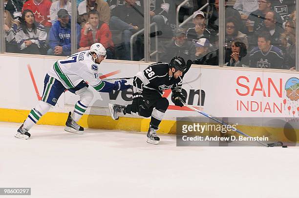 Jarret Stoll of the Los Angeles Kings skates with the puck against Ryan Kesler of the Vancouver Canucks in Game Four of the Western Conference...
