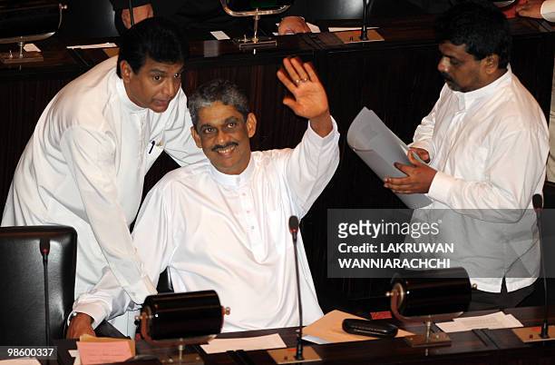 Detained former Sri Lankan Army Chief General Sarath Fonseka waves to his wife Anoma as he arrives in parliament for the inauguration of the assembly...