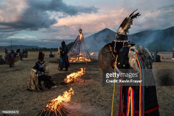 Mongolian Shamans or Buu, gather as they take part in a fire ritual to mark the period of the Summer Solstice in the grasslands on June 22, 2018...