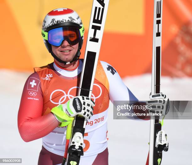 Beat Feuz from Switzerland looking at the scoreboard at the finish line during the men's alpine skiing event of the 2018 Winter Olympics in the...