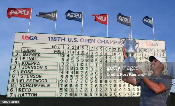 Brooks Koepka of the United States celebrates with the winners trophy after the final round of the 2018 U.S. Open at Shinnecock Hills Golf Club on...