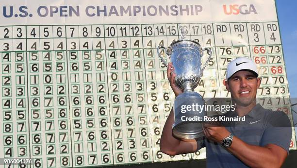 Brooks Koepka of the United States celebrates with the winners trophy after the final round of the 2018 U.S. Open at Shinnecock Hills Golf Club on...