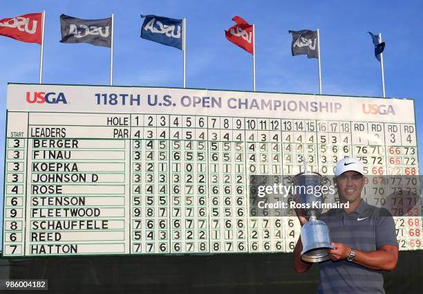 Brooks Koepka of the United States celebrates with the winners trophy after the final round of the 2018 U.S. Open at Shinnecock Hills Golf Club on...