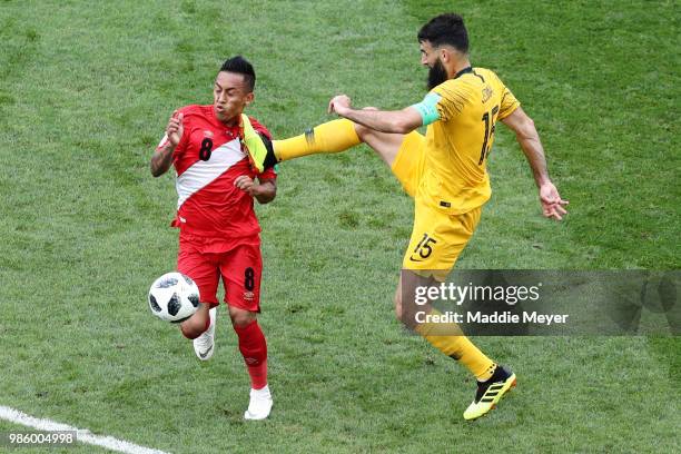 June 26: Mile Jedinak of Australia kicks Christian Cueva of Peru during the 2018 FIFA World Cup Russia group C match between Australia and Peru at...