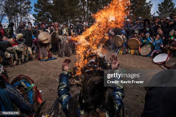 Mongolian Shamans or Buu, and their followers take part in a fire ritual meant to summon spirits at the Mother Tree on April 05, 2018 in Sukhbaatar,...