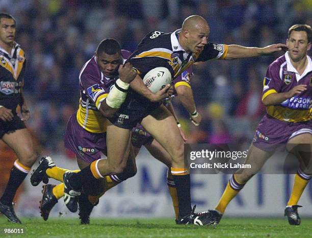 Tyran Smith of the Tigers is tackled by Petero Civoniceva of the Broncos during the round 17 NRL match between the Wests Tigers and the Brisbane...