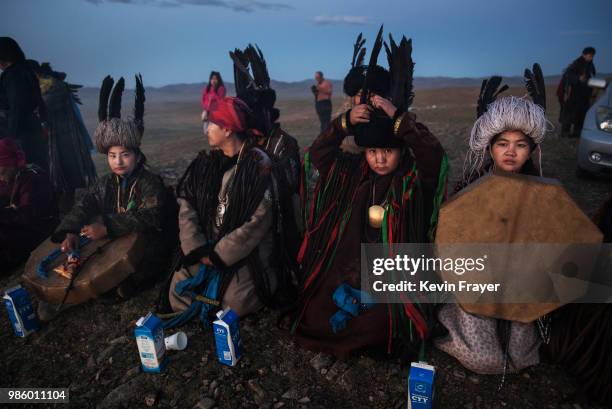 Mongolian Shamans or Buu, sit together as they take part in a sun ritual ceremony to mark the period of the Summer Solstice in the grasslands at...