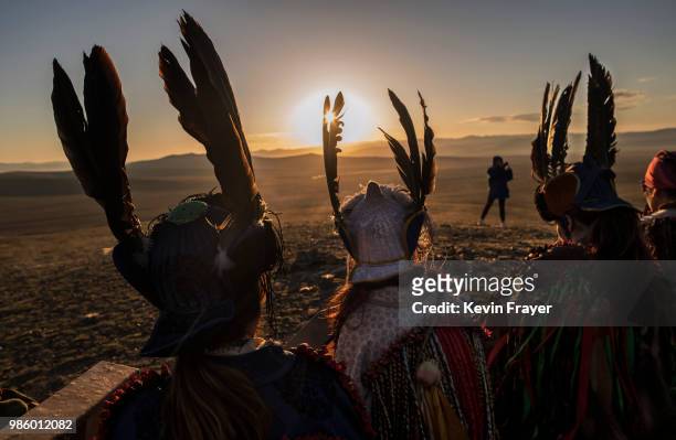 Mongolian Shamans or Buu, sit together as they take part in a sun ritual ceremony to mark the period of the Summer Solstice in the grasslands at...