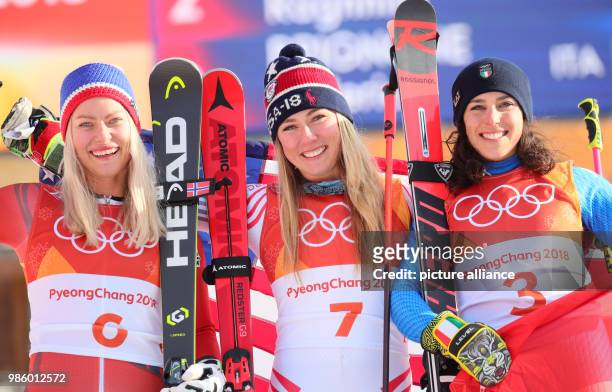 Mikaela Schiffrin from the US Ragnhild Mowinckel from Norway and Federica Brignone from Italy celebrating after the women's alpine skiing event of...