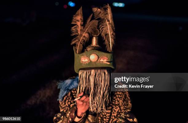 Mongolian Shaman or Buu, smokes as he is seen in trance while being consulted by followers of Shamanism or Buu murgul at a fire ritual meant to...