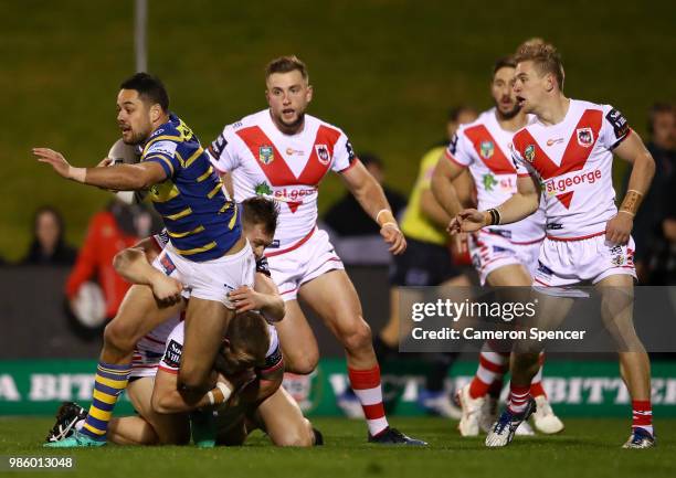 Jarryd Hayne of the Eels is tackled during the round 16 NRL match between the St George Illawarra Dragons and the Parramatta Eels at WIN Stadium on...