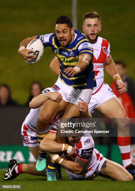 Jarryd Hayne of the Eels is tackled during the round 16 NRL match between the St George Illawarra Dragons and the Parramatta Eels at WIN Stadium on...
