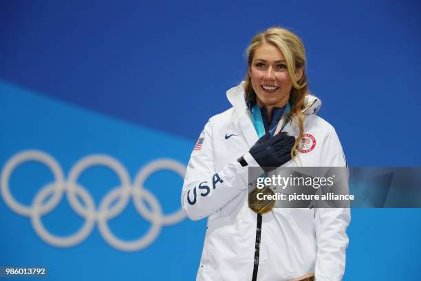 S Mikaela Shiffrin celebrates during the award ceremony after the women's alpine skiing giant slalom event of the 2018 Winter Olympics in...