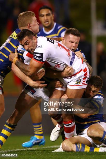 Paul Vaughan of the Dragons is tackled during the round 16 NRL match between the St George Illawarra Dragons and the Parramatta Eels at WIN Stadium...