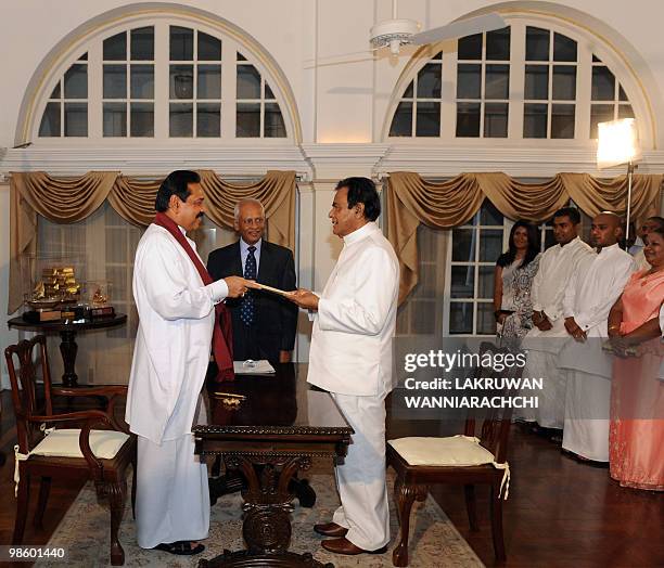 Sri Lankan President Mahinda Rajapakse administers the oath of office to the Sri Lankan Prime Minister D. M. Jayaratne in Colombo on April 21, 2010....