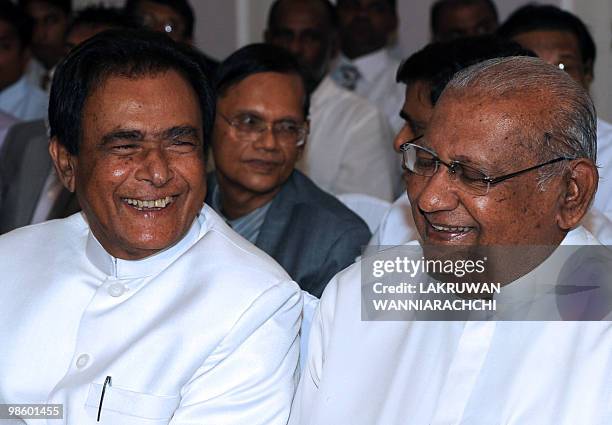 Sri Lankan new Prime Minister D. M. Jayaratne speaks with former Prime Minister Ratnasiri Wickramanayake during a swearing in ceremony in Colombo on...