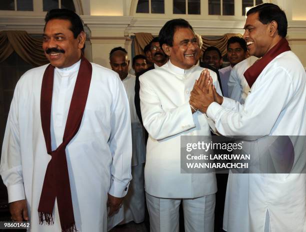 New Sri Lankan Prime Minister D. M. Jayaratne is greeted by President's younger brother Basil Rajapakse as Sri Lankan President Mahinda Rajapakse...