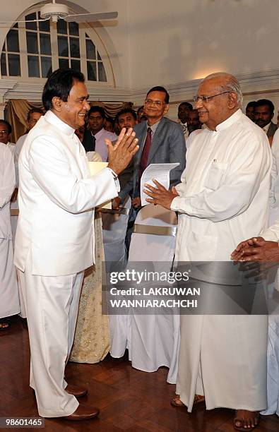 New Sri Lankan Prime Minister D. M. Jayaratne greets former Prime Minister Ratnasiri Wickramanayake during a swearing in ceremony in Colombo on April...