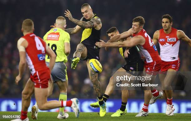 Dustin Martin of the Tigers kicks the ball during the round 15 AFL match between the Richmond Tigers and the Sydney Swans at Etihad Stadium on June...