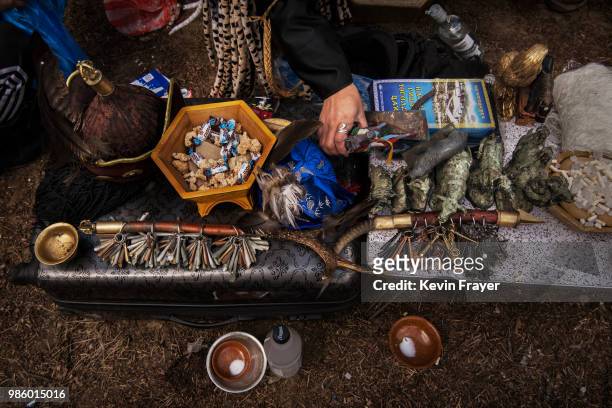 Mongolian Shaman or Buu, organizes his items for rituals meant to summon spirits at the Mother Tree on April 05, 2018 in Sukhbaatar, Selenge...
