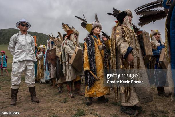 Mongolian Shamans or Buu, gather before a fire ritual meant to summon spirits to mark the period of the Summer Solstice on June 23, 2018 outside...