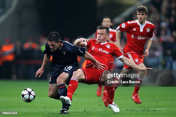 Ivica Olic of Bayern challenges Jeremy Toulalan of Lyon during the UEFA Champions League semi final first leg match between FC Bayern Muenchen and...