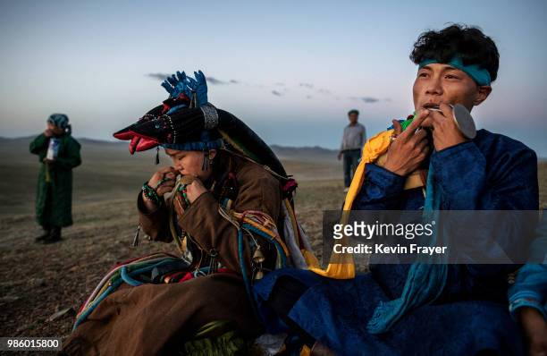 Mongolian Shamans or Buu, play the mouth harp or khel khurr, used to summon spirits, during a sun ritual ceremony to mark the period of the Summer...